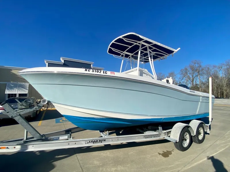 Slide: The Image of 2016 Clearwater 2200CC boat on a trailer in a parking lot. - 5