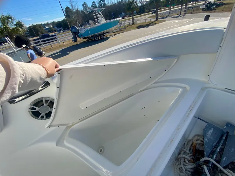 Slide: The Image of 2016 Clearwater 2200CC boat storage compartment open, showing interior space. - 25