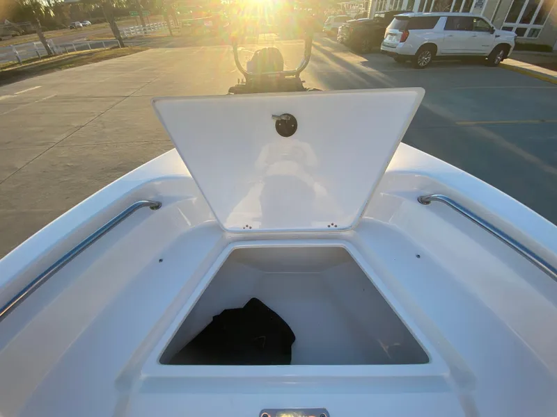 Slide: The Image of 2020 Key West 189 FS boat with open storage compartment at sunset. - 18