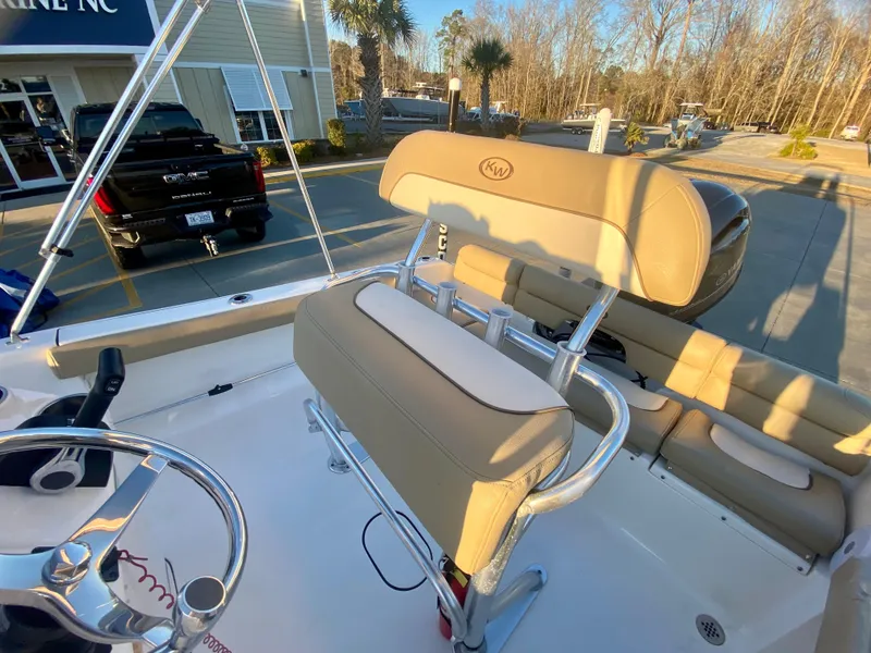 Slide: The Image of 2020 Key West 189 FS boat interior with beige seating and steering wheel. - 9