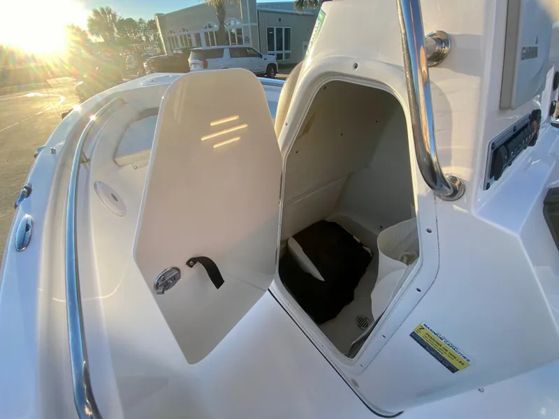 Slide: The Image of 2020 Key West 189 FS boat storage compartment with open door at sunset. - 14