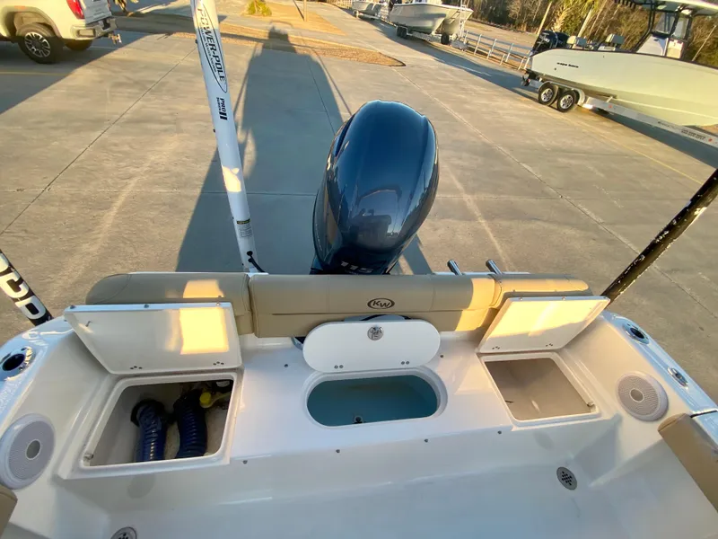 Slide: The Image of 2020 Key West 189 FS boat stern view with outboard motor and storage compartments. - 8