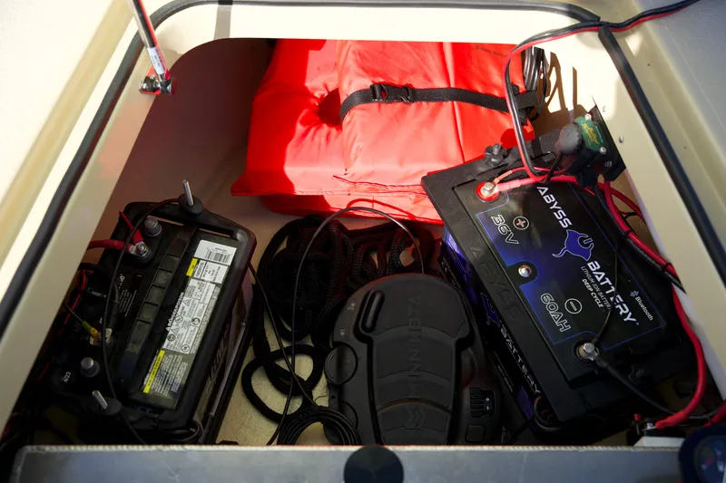 Slide: The Image of Storage compartment of 2023 Cayo Boatworks 180 with batteries and life jacket. - 18
