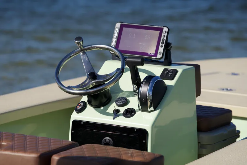 Slide: The Image of 2023 Cayo Boatworks 180 console with steering wheel and navigation system. - 5