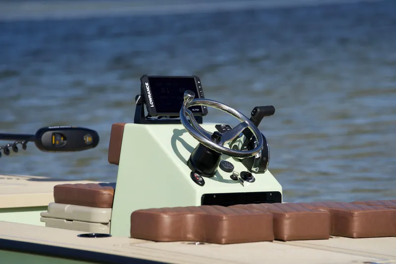 Slide: The Image of 2023 Cayo Boatworks 180 console with steering wheel and navigation system. - 6