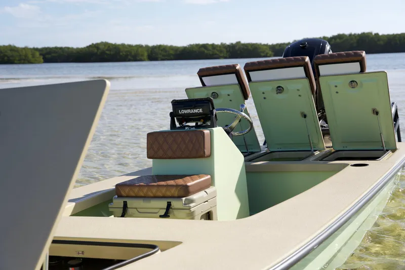 Slide: The Image of 2023 Cayo Boatworks 180 model in shallow water with open storage compartments. - 9