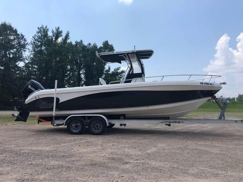 The Image of 2006 Sea Chaser 245 LX Bay Runner boat on a trailer. - 1