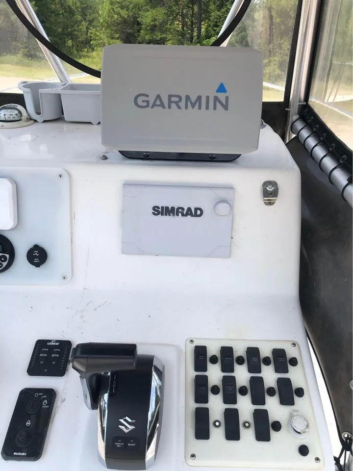 Slide: The Image of Control panel of a 2006 Sea Chaser 245 LX Bay Runner with Garmin and Simrad equipment. - 3