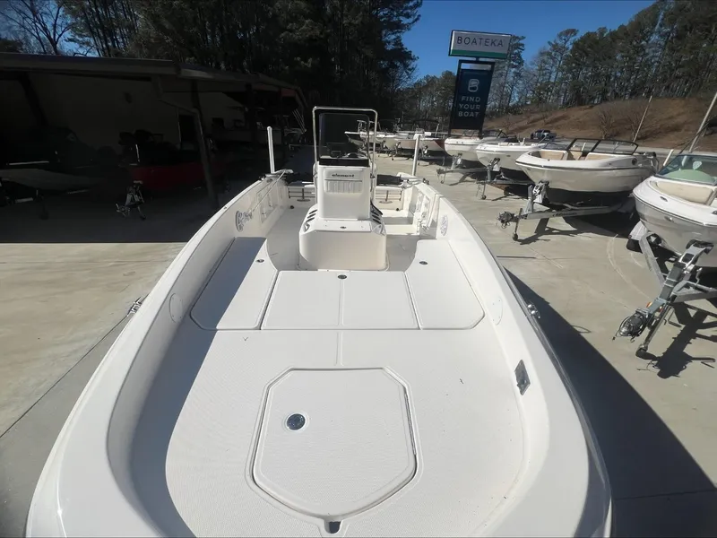 Slide: The Image of 2021 Bayliner E21 boat on display at a dealership. - 6