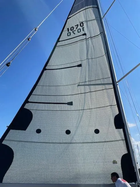 Slide: The Image of 2024 M.A.T. 1070 sailboat mast and sail against blue sky - 18
