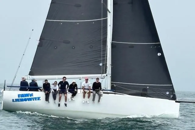 Slide: The Image of Sailing yacht M.A.T. 1070, 2024 model, with crew on deck in open water. - 2