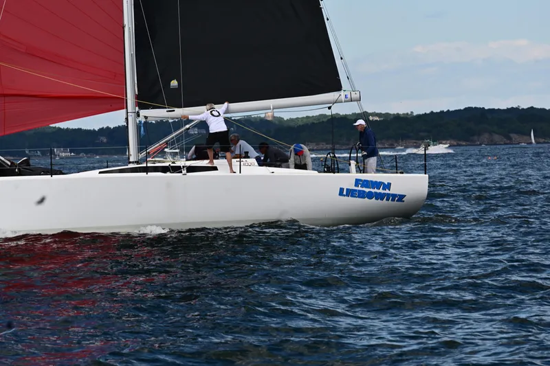 Slide: The Image of Sailing yacht M.A.T. 1070, 2024 model, with red and black sails on open water. - 20