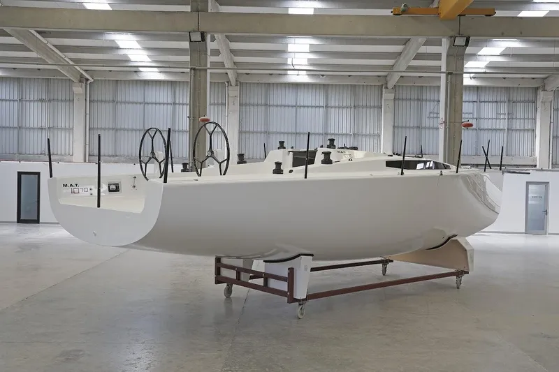 Slide: The Image of 2024 M.A.T. 1070 sailboat in a modern indoor facility - 5