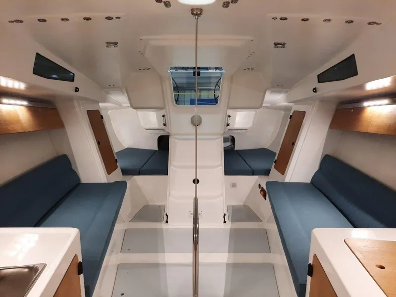 Slide: The Image of Interior of 2024 M.A.T. 1070 sailboat with blue seating and modern design. - 7