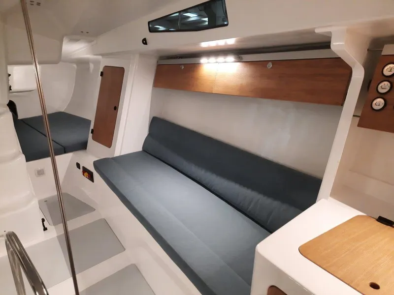 Slide: The Image of 2024 M.A.T. 1070 yacht interior with modern seating and wooden accents. - 8