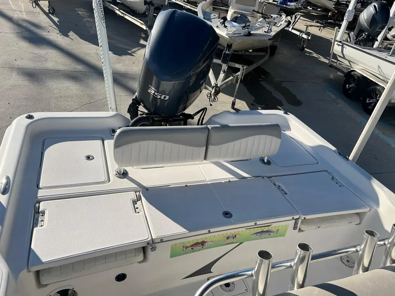 Slide: The Image of 2011 Blue Wave Pure Bay 2400 boat with 350 HP engine, rear seating, and storage compartments. - 6