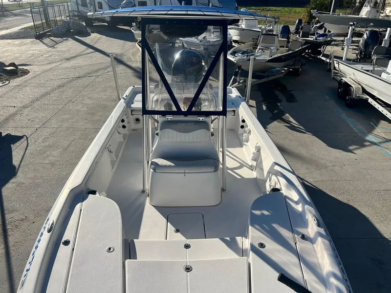 Slide: The Image of 2011 Blue Wave Pure Bay 2400 boat, center console, docked at marina. - 9