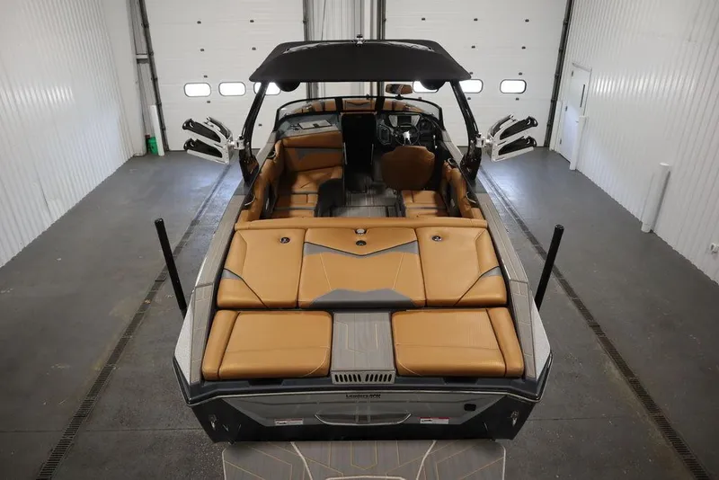 Slide: The Image of 2024 Supreme ZS232 boat with tan interior in a garage. - 10