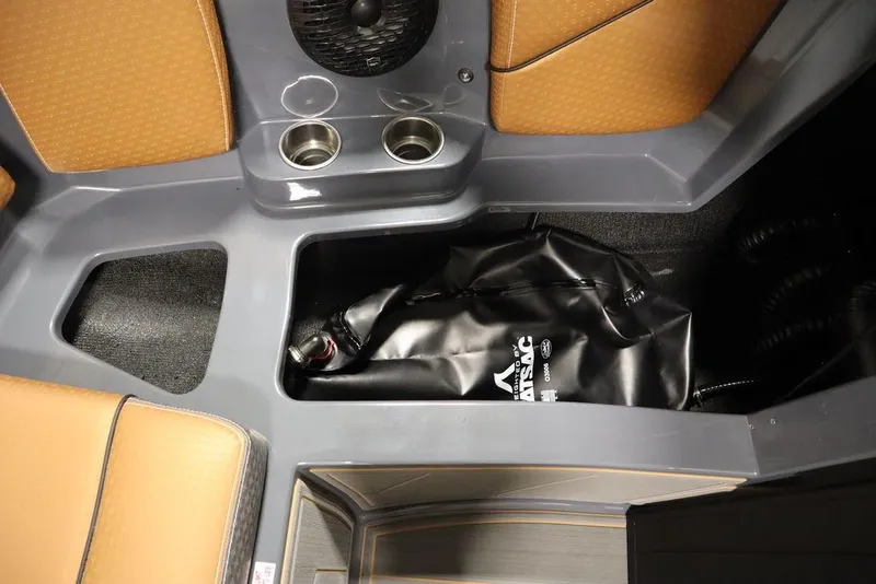 Slide: The Image of 2024 Supreme ZS232 boat interior storage compartment with ballast bag and cup holders. - 15