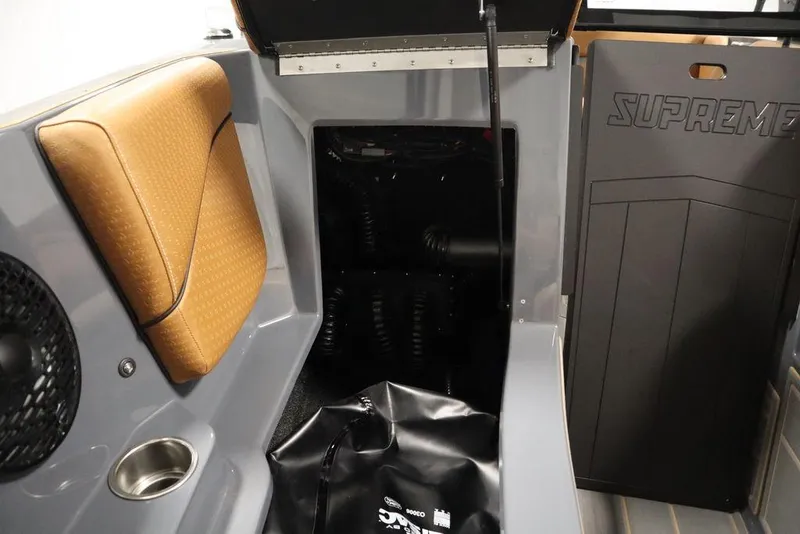 Slide: The Image of 2024 Supreme ZS232 boat interior with tan seating and storage compartment. - 16