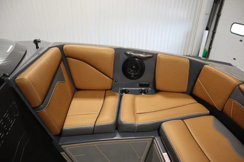 Slide: The Image of 2024 Supreme ZS232 boat interior with tan and gray cushioned seating. - 17