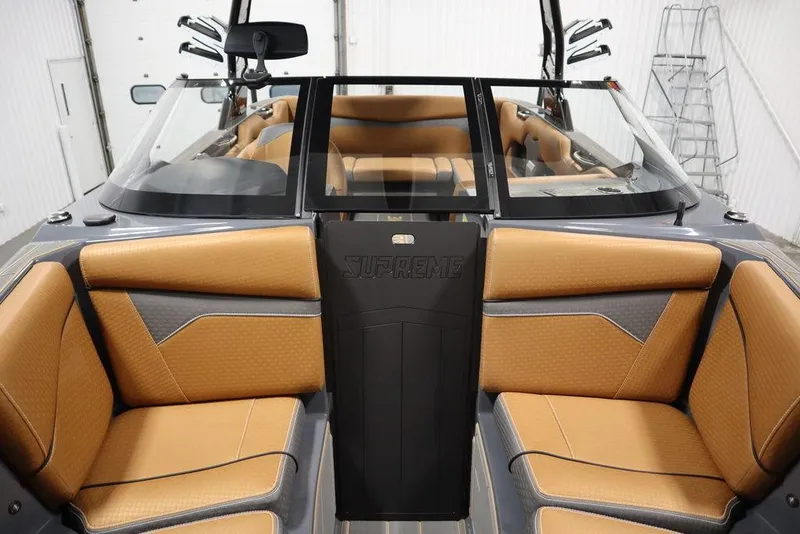 Slide: The Image of 2024 Supreme ZS232 boat interior with tan and gray seating. - 18