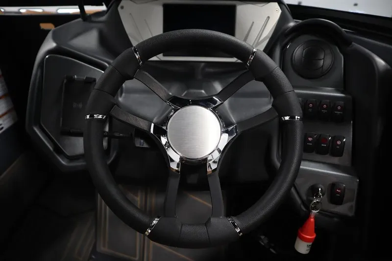 Slide: The Image of 2024 Supreme ZS232 boat steering wheel and dashboard controls. - 22