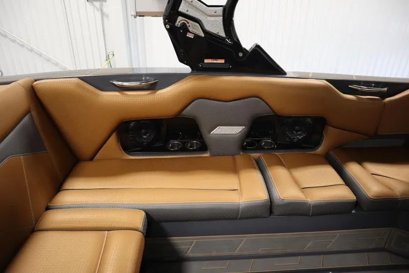 Slide: The Image of 2024 Supreme ZS232 boat interior with tan leather seating and built-in speakers. - 47
