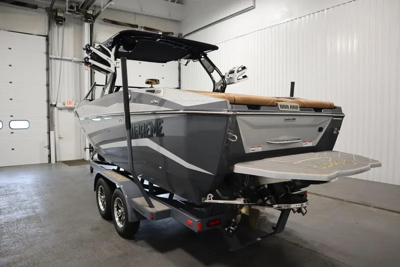 Slide: The Image of 2024 Supreme ZS232 boat in a garage, rear view. - 7