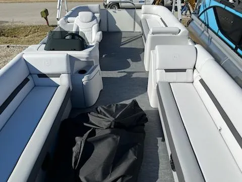 Slide: The Image of 2024 Sweetwater 2286SB pontoon boat interior with white seating and helm station. - 6