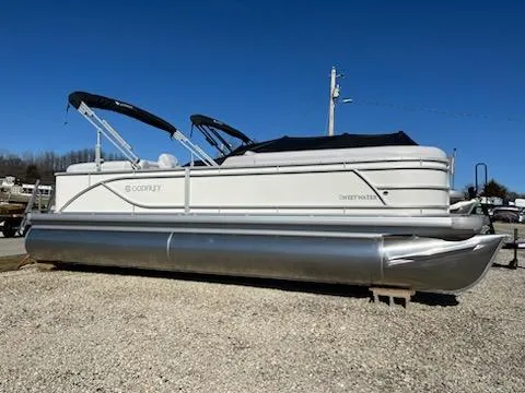 Slide: The Image of 2024 Sweetwater 2286SB pontoon boat on gravel lot under clear blue sky. - 7