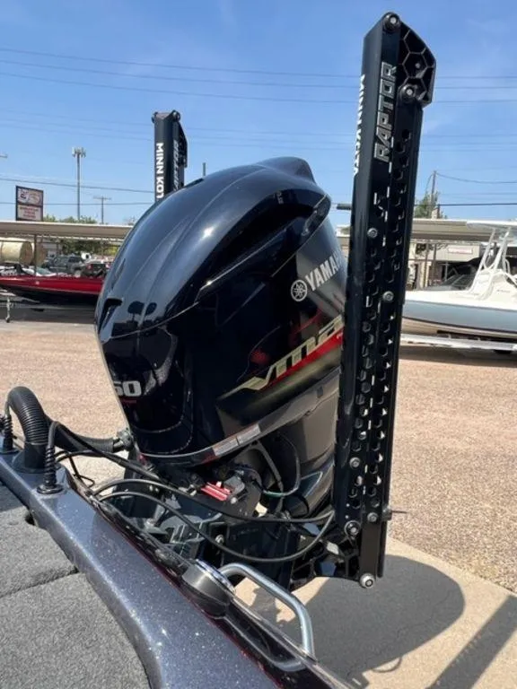 Slide: The Image of 2014 Skeeter 20i boat with Yamaha VMAX outboard motor, parked outside a dealership. - 2