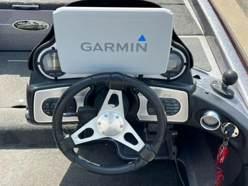 Slide: The Image of 2014 Skeeter 20i boat dashboard with steering wheel and control panel. - 9