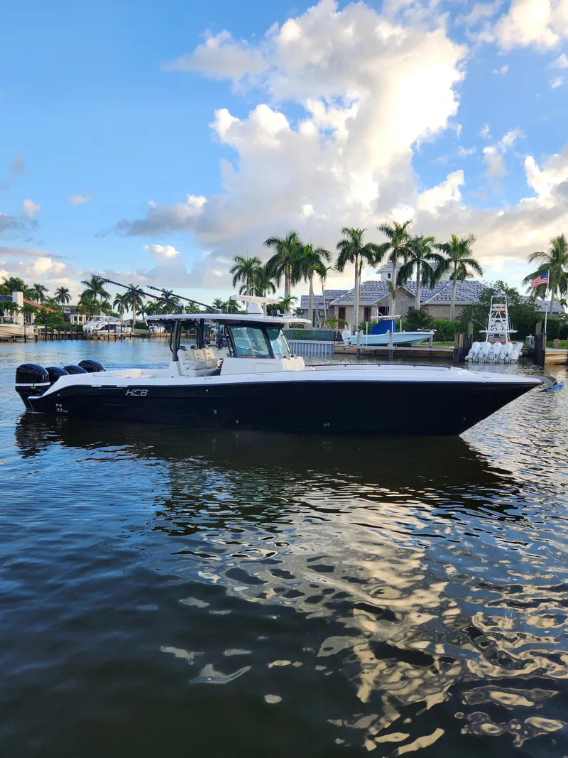 Slide: The Image of 2019 HCB 39 Speciale boat on calm water with palm trees in the background. - 11