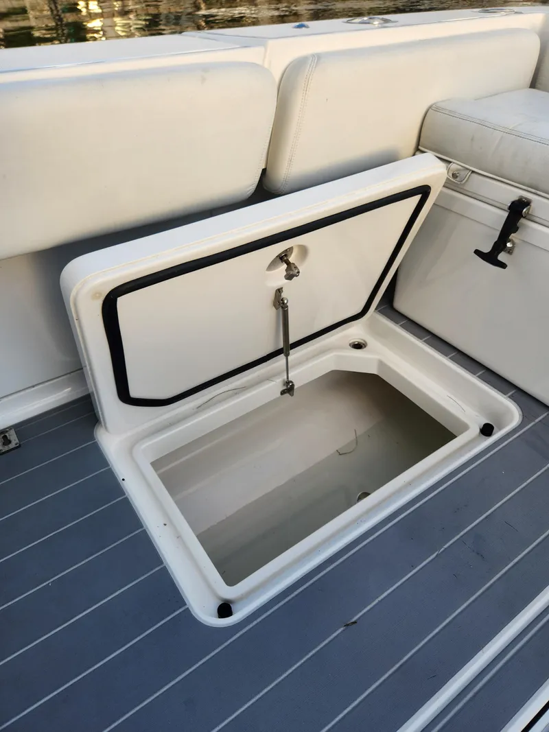 Slide: The Image of Open storage compartment on 2019 HCB 39 Speciale boat with cushioned seating. - 18
