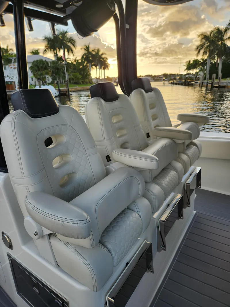 Slide: The Image of Luxurious seating on 2019 HCB 39 Speciale boat, with sunset view and palm trees. - 22