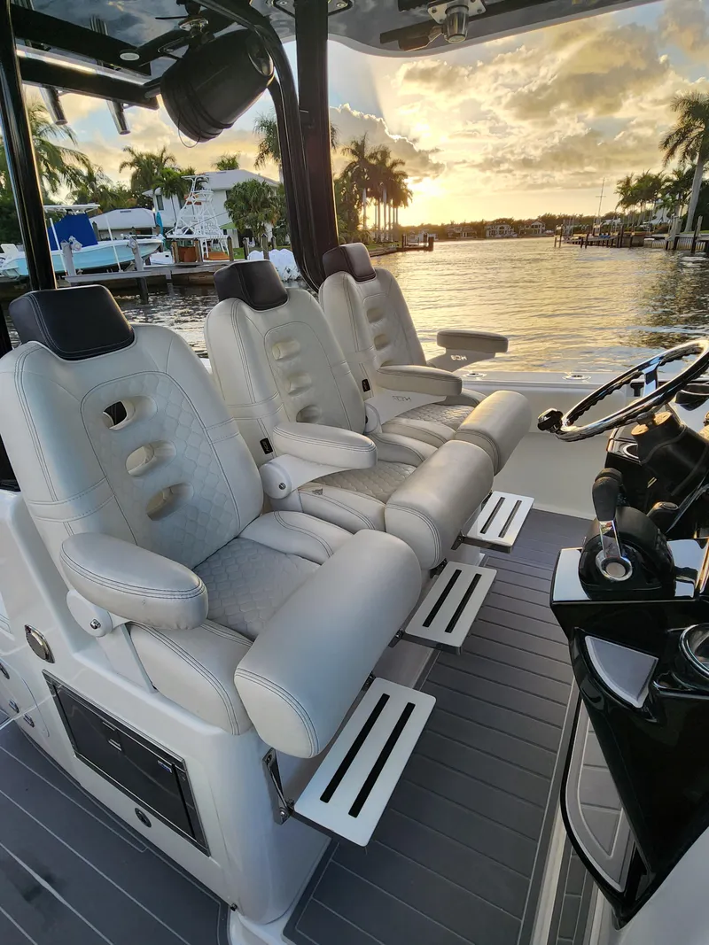 Slide: The Image of Luxurious seating on 2019 HCB 39 Speciale boat, with sunset view over water. - 23