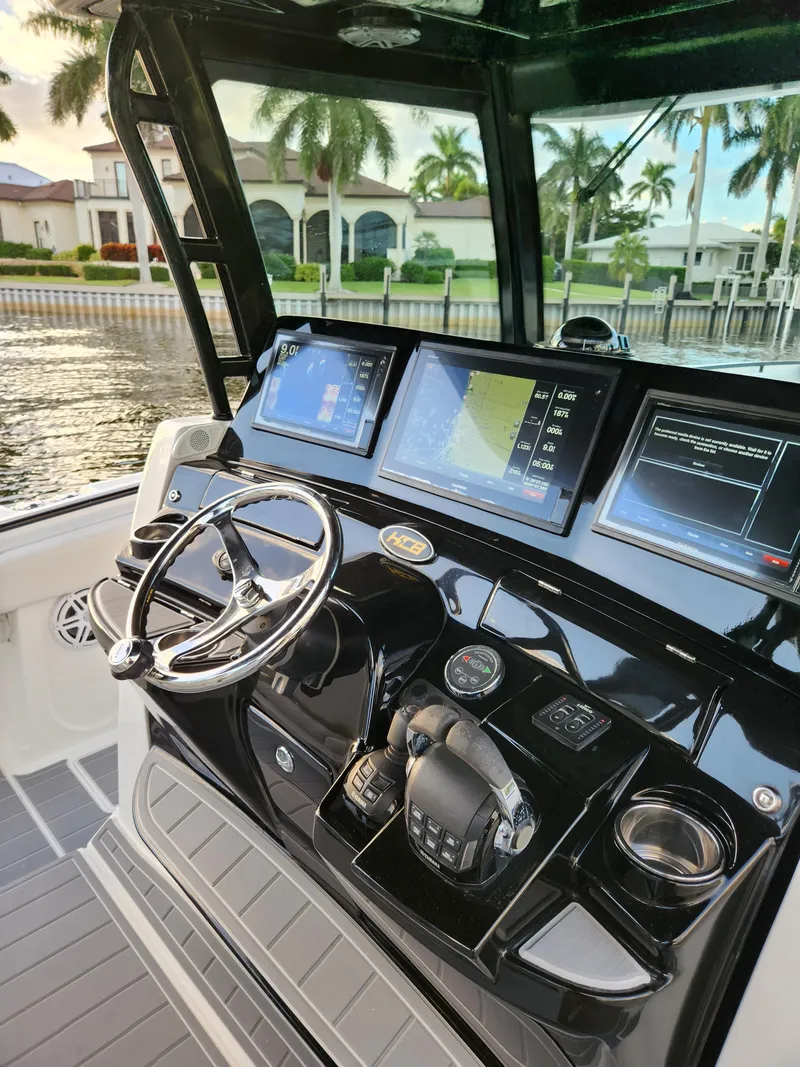 Slide: The Image of 2019 HCB 39 Speciale boat dashboard with advanced navigation screens and controls. - 24