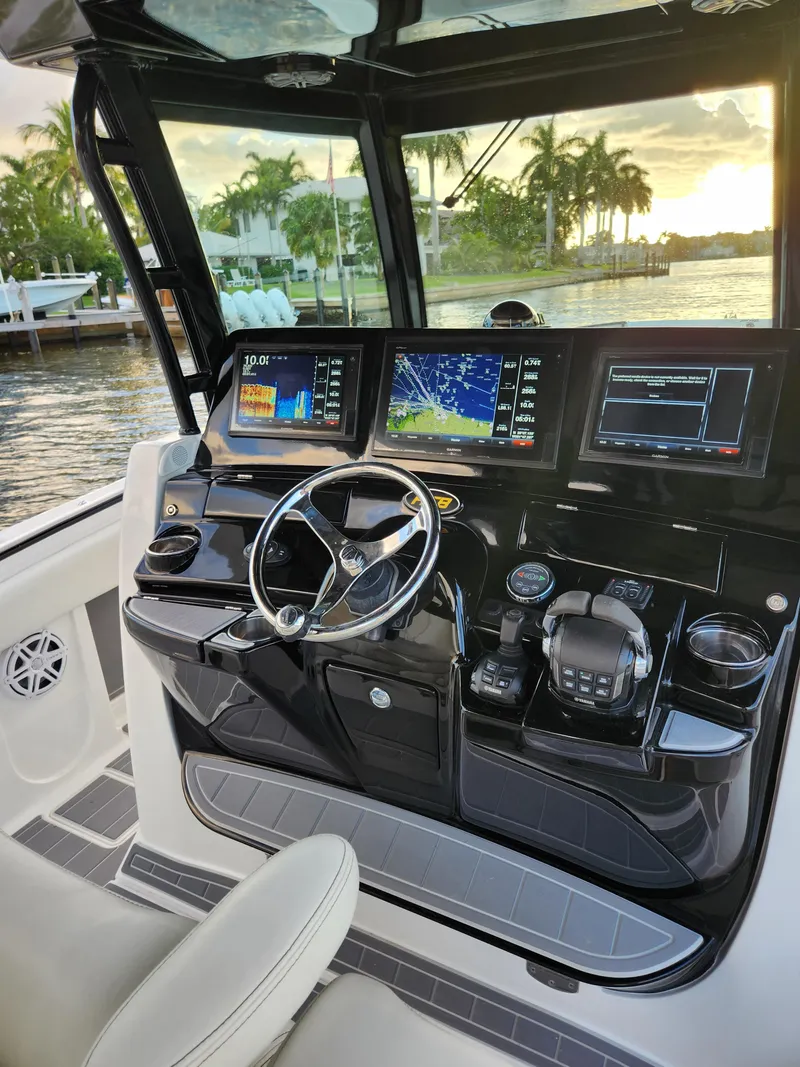 Slide: The Image of 2019 HCB 39 Speciale boat cockpit with advanced navigation displays and steering wheel. - 25