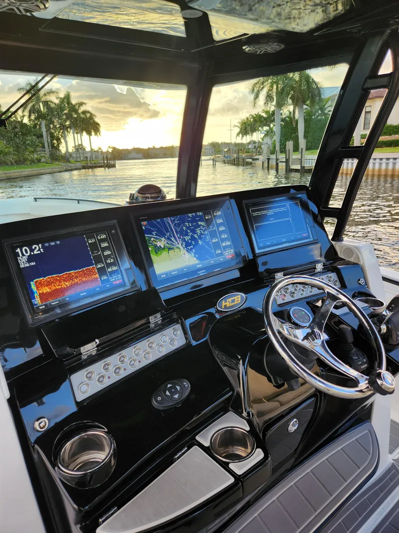 Slide: The Image of 2019 HCB 39 Speciale boat dashboard with advanced navigation screens at sunset. - 27