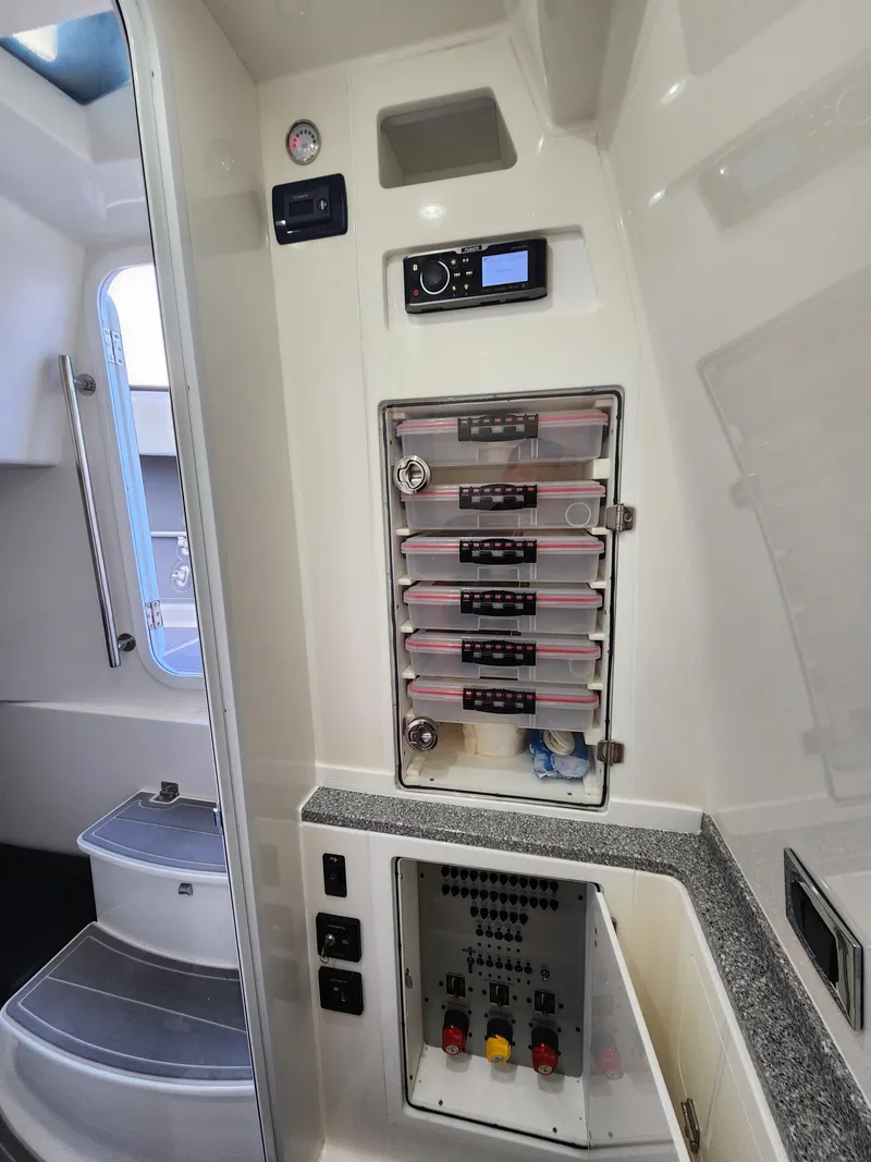 Slide: The Image of Interior of 2019 HCB 39 Speciale boat showing control panels and storage compartments. - 30