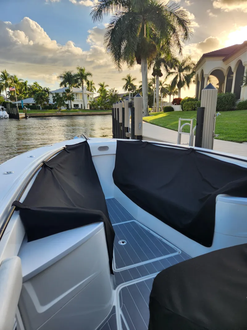 Slide: The Image of 2019 HCB 39 Speciale boat docked by palm trees and waterfront homes. - 35