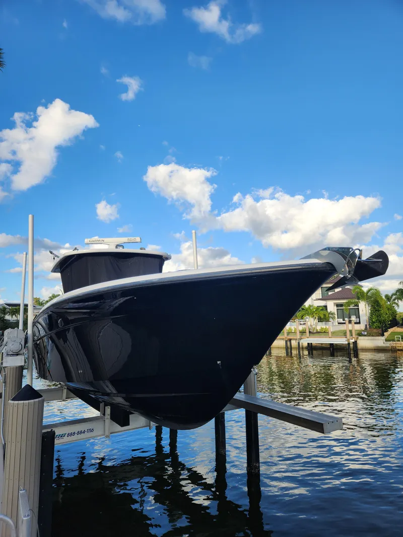 Slide: The Image of 2019 HCB 39 Speciale boat on lift against blue sky and clouds. - 4