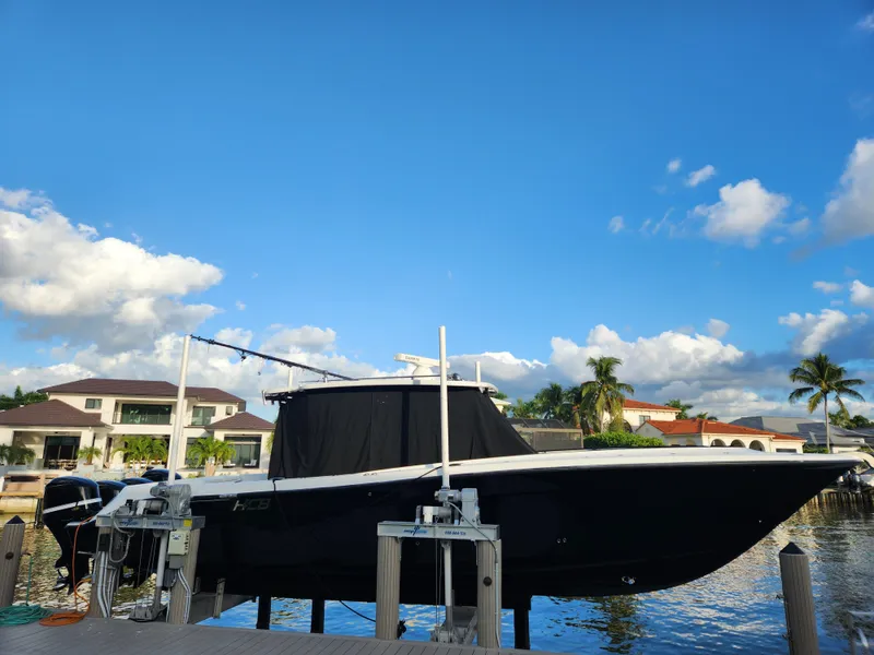 Slide: The Image of 2019 HCB 39 Speciale boat docked by waterfront homes under a clear blue sky. - 5