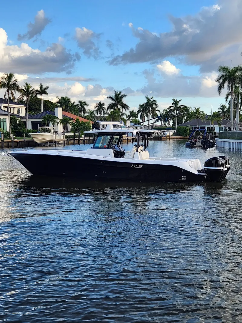 Slide: The Image of 2019 HCB 39 Speciale boat on a scenic waterway with palm trees and blue sky. - 7