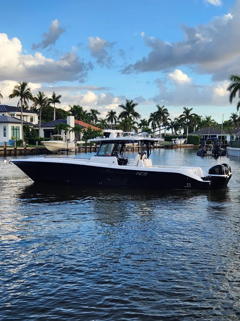 Slide: The Image of 2019 HCB 39 Speciale boat cruising in a scenic canal with palm trees. - 8