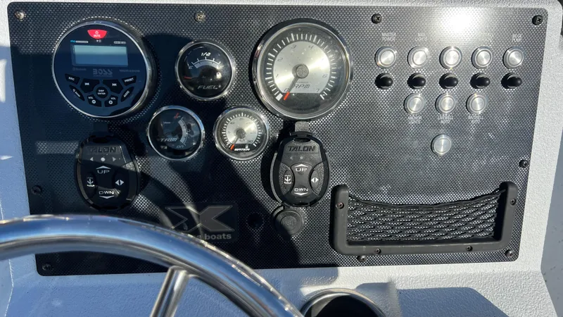 Slide: The Image of 2019 Xpress H24B boat dashboard with gauges and controls. - 11