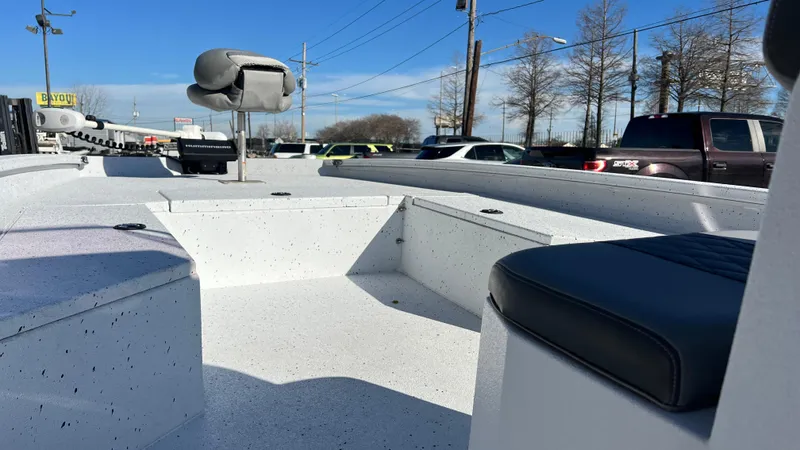 Slide: The Image of 2019 Xpress H24B boat interior with seating and storage compartments. - 12