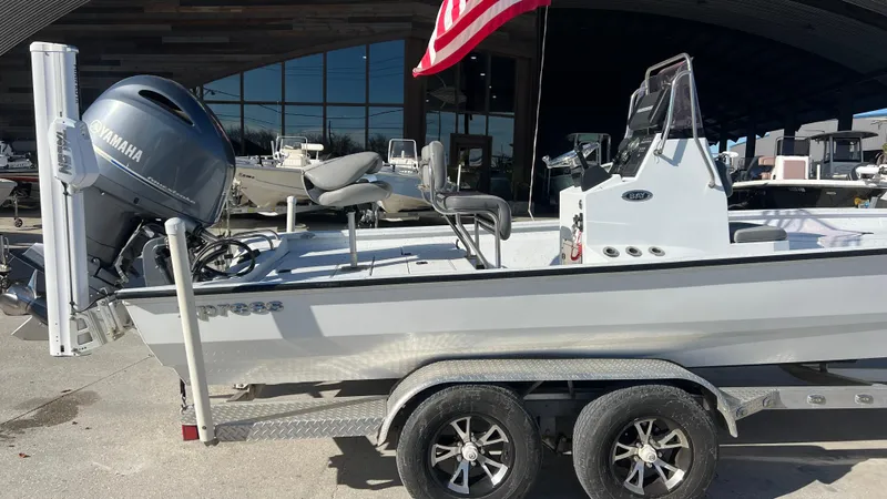 Slide: The Image of 2019 Xpress H24B boat on trailer with Yamaha outboard motor. - 2