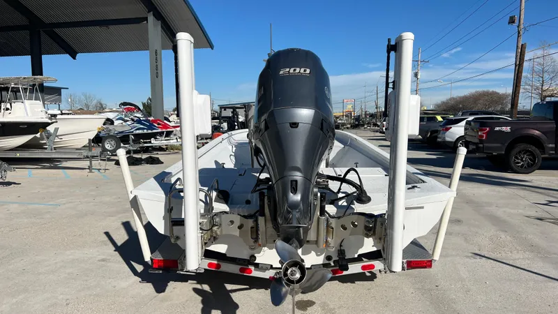 Slide: The Image of 2019 Xpress H24B boat with 200 HP engine, rear view at a dealership. - 3